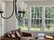 Living room showcasing large windows, natural light, and comfortable, patterned vintage furniture at 1013 Greatland Road, Durham, NC 27703