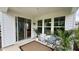 Relaxing outdoor patio features a sliding glass door and is decorated with plants and comfortable seating at 1013 Greatland Road, Durham, NC 27703