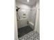 Modern tiled shower with a glass enclosure and a built-in seat at 1013 Greatland Road, Durham, NC 27703