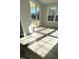 Bright sunroom featuring light wood floors, large windows, and a sliding glass door to the backyard at 1013 Greatland Road, Durham, NC 27703