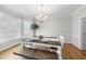 Charming dining room featuring hardwood floors, a chandelier, and ample natural light at 107 White Sands Dr, Cary, NC 27513