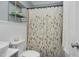 Cozy bathroom featuring a shower with floral curtain, toilet, and towel rack at 109 Mary Ln, Rocky Mount, NC 27803