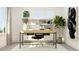 Bright home office featuring a modern desk, stylish decor, a comfortable chair, and ample natural light at 1205 Jade Valley Trl, Raleigh, NC 27610