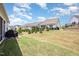 Backyard with a well-maintained lawn, screened porch, and tasteful landscaping at 130 Ivory Ln, Raleigh, NC 27610