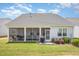 Backyard featuring a screened-in porch and well-maintained lawn at 130 Ivory Ln, Raleigh, NC 27610