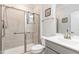 Bathroom featuring a glass-enclosed shower with tiled walls, a modern toilet, and a vanity with a sink at 130 Ivory Ln, Raleigh, NC 27610