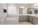Relaxing bathroom with a soaking tub, double vanity, and ample storage space at 130 Ivory Ln, Raleigh, NC 27610