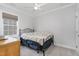 Bright bedroom with a wrought iron bed frame, a window, neutral walls and carpet, and a ceiling fan at 130 Ivory Ln, Raleigh, NC 27610