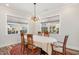 Well-lit dining room featuring a classic chandelier and views of the backyard at 130 Ivory Ln, Raleigh, NC 27610