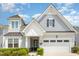 Charming home featuring a mix of gray shingle and lap siding and a black front door at 130 Ivory Ln, Raleigh, NC 27610