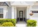 Close up of the entryway with a black front door and stylish stonework accents at 130 Ivory Ln, Raleigh, NC 27610