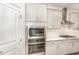 Bright kitchen with stainless steel oven and microwave combo built into the gray shaker cabinetry at 130 Ivory Ln, Raleigh, NC 27610