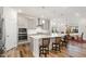 Modern kitchen featuring a large island, stainless steel appliances, and sleek white countertops at 130 Ivory Ln, Raleigh, NC 27610