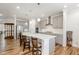 Contemporary kitchen with stainless steel appliances, quartz counters, and breakfast bar seating at 130 Ivory Ln, Raleigh, NC 27610
