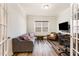 Cozy living room with hardwood floors, comfortable sofa, and plenty of natural light at 130 Ivory Ln, Raleigh, NC 27610