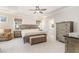 Comfortable main bedroom with neutral carpeting, ceiling fan, and ensuite bathroom entrance at 130 Ivory Ln, Raleigh, NC 27610