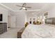 Spacious main bedroom with carpet, tray ceiling, fan, and seating area with views at 130 Ivory Ln, Raleigh, NC 27610