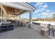 Covered patio area with wooden ceiling, ceiling fans, multiple tables and chairs, lounge furniture, and outdoor pool at 130 Ivory Ln, Raleigh, NC 27610