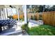 Relaxing back porch with outdoor seating, artificial turf, and stone landscaping at 1317 Pecora Ln, Raleigh, NC 27607