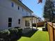 Backyard view with lush artificial grass, covered patio, and manicured landscaping at 1317 Pecora Ln, Raleigh, NC 27607