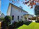 Backyard view with lush artificial grass, covered patio, and manicured landscaping at 1317 Pecora Ln, Raleigh, NC 27607