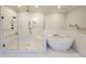 Elegant bathroom featuring a soaking tub and a glass walk-in shower with bronze fixtures at 1317 Pecora Ln, Raleigh, NC 27607