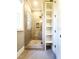 Modern bathroom featuring glass shower with built-in shelving and neutral tile, and linen closet at 1317 Pecora Ln, Raleigh, NC 27607