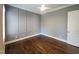 Cozy bedroom features dark hardwood floors, wainscoting, a ceiling fan, and neutral gray paint at 1317 Pecora Ln, Raleigh, NC 27607