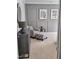 Tastefully decorated bedroom with a comfortable chair, ottoman, and elegant wall art at 1317 Pecora Ln, Raleigh, NC 27607
