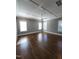 Large bedroom with hardwood floors, large windows, and a ceiling fan at 1317 Pecora Ln, Raleigh, NC 27607