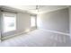Bright, carpeted bedroom features two large windows and a ceiling fan at 1317 Pecora Ln, Raleigh, NC 27607