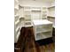 Walk-in closet featuring shelving and hanging storage, an island, and hardwood floors at 1317 Pecora Ln, Raleigh, NC 27607