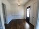 Bright dining room featuring hardwood floors, a decorative light fixture, and crisp white wainscoting at 1317 Pecora Ln, Raleigh, NC 27607