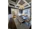 Elegant dining room featuring a coffered ceiling, large windows, and stylish furnishings at 1317 Pecora Ln, Raleigh, NC 27607