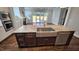 Kitchen island features stainless steel sink, dishwasher, and seating area at 1317 Pecora Ln, Raleigh, NC 27607
