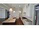 Open concept kitchen with island, white cabinets, and view of the living room at 1317 Pecora Ln, Raleigh, NC 27607