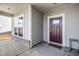 Covered front porch featuring a stylish, dark-brown front door with sidelight windows at 1416 Monterey Bay Dr, Wake Forest, NC 27587