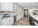 This modern butler's pantry features stainless appliances, recessed lighting, and stylish white cabinets at 1416 Monterey Bay Dr, Wake Forest, NC 27587