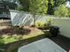 Private backyard with new landscaping, a modern fence, and a small patio area at 1551 Crescent Townes Way, Raleigh, NC 27604