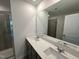 Bathroom boasts double sink vanity with modern fixtures, large mirror, and glass door shower at 1551 Crescent Townes Way, Raleigh, NC 27604