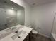 Modern bathroom with vanity, large mirror, and tile flooring at 1551 Crescent Townes Way, Raleigh, NC 27604