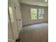 Bright bedroom featuring neutral carpet, natural light from double windows, and a spacious closet at 1551 Crescent Townes Way, Raleigh, NC 27604