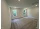 Spacious and bright carpeted bedroom featuring double windows and overhead lighting at 1551 Crescent Townes Way, Raleigh, NC 27604