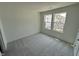 Neutral carpeted bedroom featuring natural light, double windows, and a calming atmosphere at 1551 Crescent Townes Way, Raleigh, NC 27604