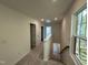 Upstairs hallway features neutral carpet, recessed lighting, and stairway overlooking outdoors at 1551 Crescent Townes Way, Raleigh, NC 27604
