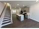Open-concept kitchen featuring gray cabinets, stainless steel appliances, and large island at 1551 Crescent Townes Way, Raleigh, NC 27604