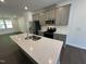 Modern kitchen with an island, stainless steel appliances, and gray cabinets at 1551 Crescent Townes Way, Raleigh, NC 27604