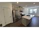 Well-appointed kitchen featuring a large island, stainless steel appliances, and gray cabinets at 1551 Crescent Townes Way, Raleigh, NC 27604