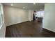 Spacious open-concept living room showcasing hardwood floors and kitchen access at 1551 Crescent Townes Way, Raleigh, NC 27604