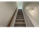 Carpeted staircase with wooden handrail leading to upper level at 1551 Crescent Townes Way, Raleigh, NC 27604